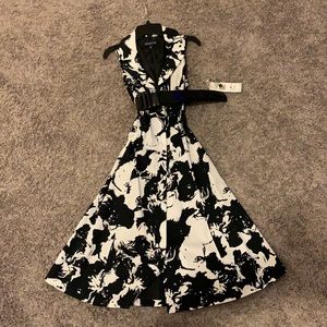 A-line abstract black & white button-front dress with faux patent leather belt.